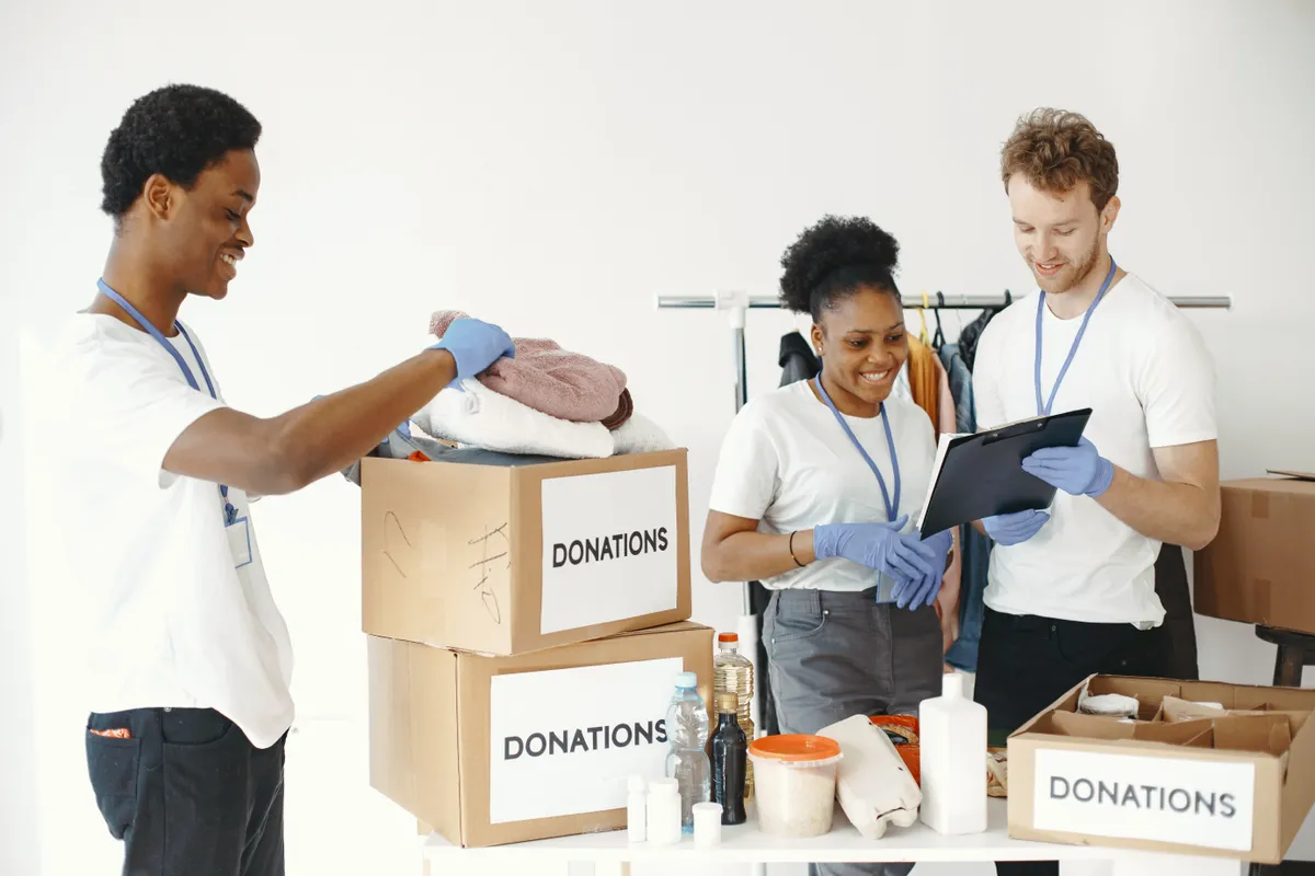 Unsold items packed into donation boxes during post-sale cleanup